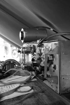 An old film projector on a table.
