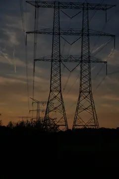 Electricity pylons against the evening sky.